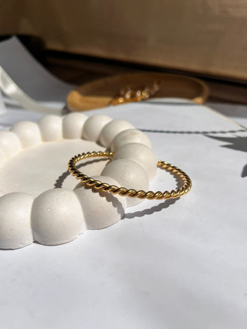 Thin twisted bangle